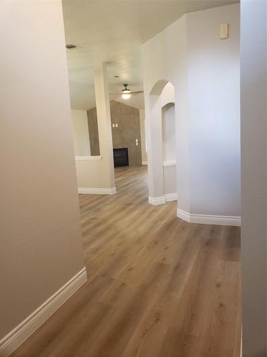 Hall with baseboards, wood finished floors, and a
