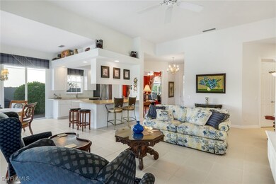 Tiled living room featuring ceiling fan with notab