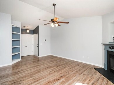 The living room offers beautiful built ins and a coat closet!