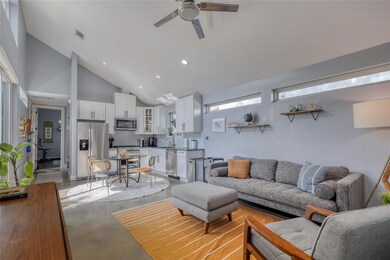 Living area with finished concrete flooring, high