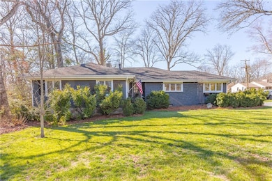 View of front facade featuring a front lawn, a sun