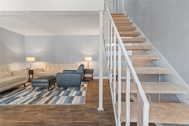 Living room featuring wood finished floors and stairs