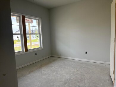 Unfurnished room with concrete floors and baseboards