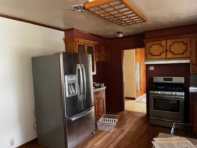Kitchen with high end fridge, range, a textured ce