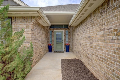 Doorway to property with brick siding and a shingled roof