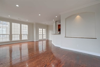 Large windows and a French door leading to the balcony.
