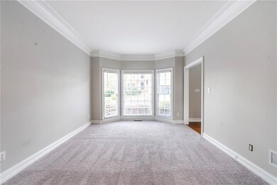 Carpeted empty room with ornamental molding