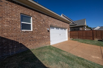 View of home's exterior featuring a lawn and a gar