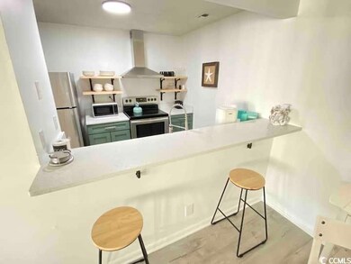Kitchen featuring wall chimney exhaust hood, a kit