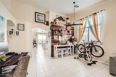 Dining area featuring arched walkways, tile patter