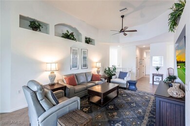 Living room with a towering ceiling, baseboards, t
