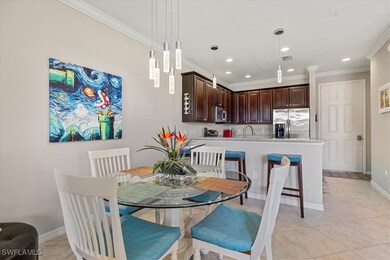 Tiled dining area featuring ornamental molding and