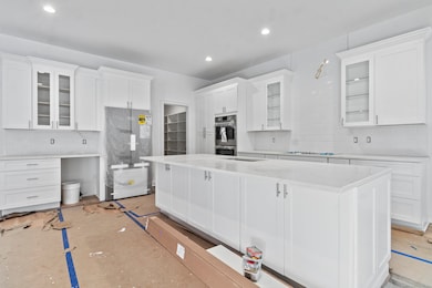 Beautiful chefs kitchen with white quartz and Bosc