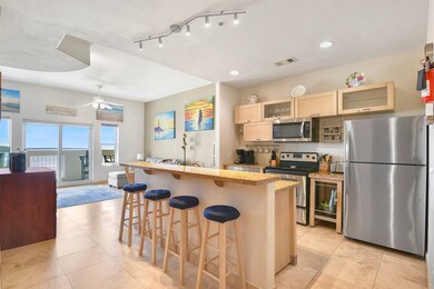 The open floor plan unit has Travertine tile, rece