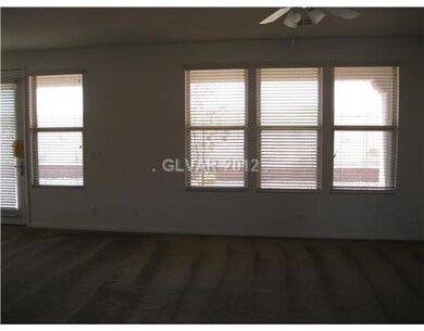 Living Room. Lots of windows!  Blinds are included