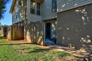 View of home's exterior with a patio and a lawn
