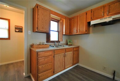 Spacious kitchen is bright and airy. Mud room / re
