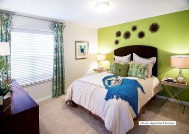 Carpeted bedroom with a textured ceiling and baseboards