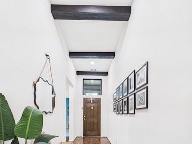 Entry with tall ceilings detailed with beams