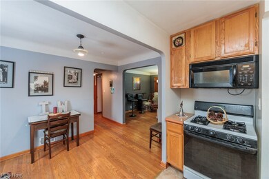 Kitchen featuring light wood-type flooring, gas range gas stove, and hanging light fixtures