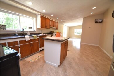KITCHEN LOOKING ONTO FAMILY ROOM AREA