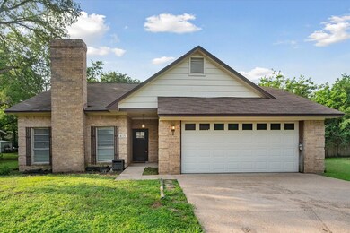 View of front of house with a front lawn, a garage, and central air condition unit