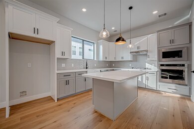 This modern kitchen features sleek cabinetry, stai