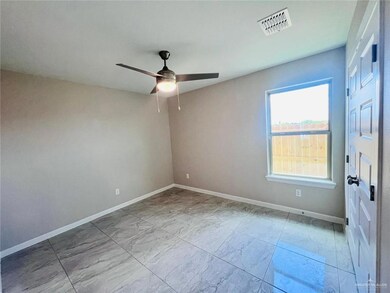 Unfurnished room with marble finish floor, baseboards, a ceiling fan, and visible vents