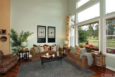 Large picture windows open to multiple fairway gol