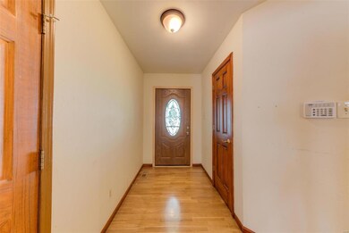 Custom front door leads to hardwood floor entry ar