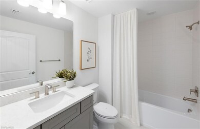 Full bathroom featuring vanity with extensive cabi