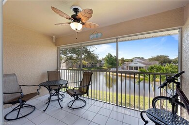 Balcony featuring a water view, ceiling fan, and a residential view