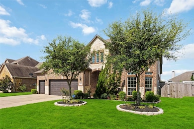Curb appeal with rich landscape.