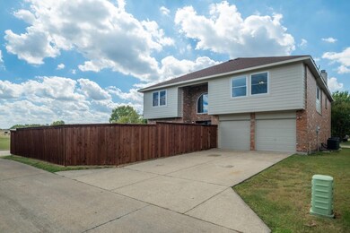 Bi-level home featuring cooling unit, a garage, an