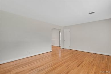 Family room featuring refinished hardwood flooring