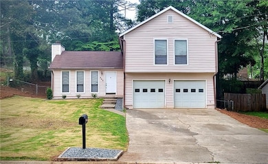 Split level home featuring a front lawn, an attach