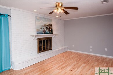Family room features wood burning fireplace. Crown