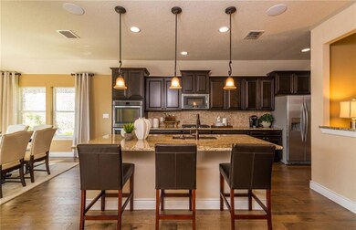 Large island kitchen with eat-in bartop *Photos of