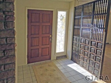 Formal entry with natural light and coat closet.