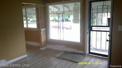 Doorway featuring plenty of natural light and wood finished floors