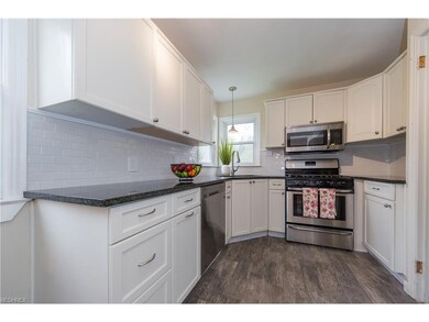 This sparkling kitchen has new black granite count