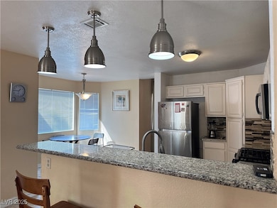 Kitchen featuring stainless steel appliances, dark