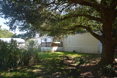 View of green lawn featuring a deck