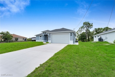 View of front of house with stucco siding, drivewa