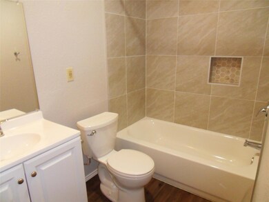 Bathroom featuring vanity, wood finished floors, 