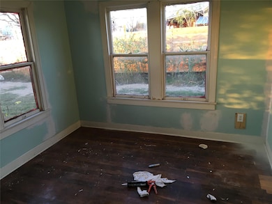 Unfurnished room with dark wood-type flooring and