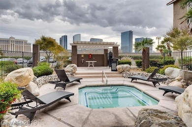 View of pool with a pergola, fence, a patio area, and a view of city