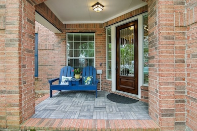 Charming brick front porch with a cozy seating are