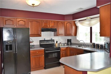 Cherry cabinetry throughout the open kitchen ccome
