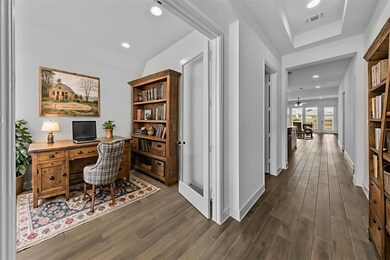 Office space with dark wood finished floors and r